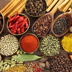 Spices and herbs in metal  bowls and wooden spoons. Food and cuisine ingredients.